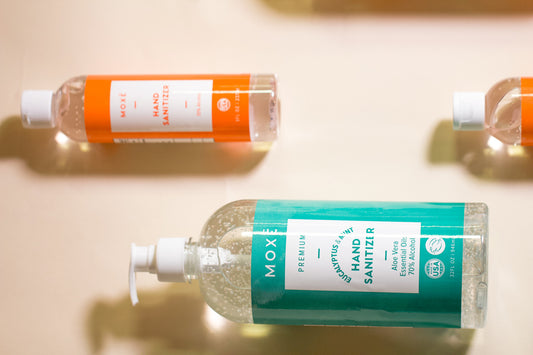 Moxe hand sanitizer citus and eucalyptus on lying down on lying beige background