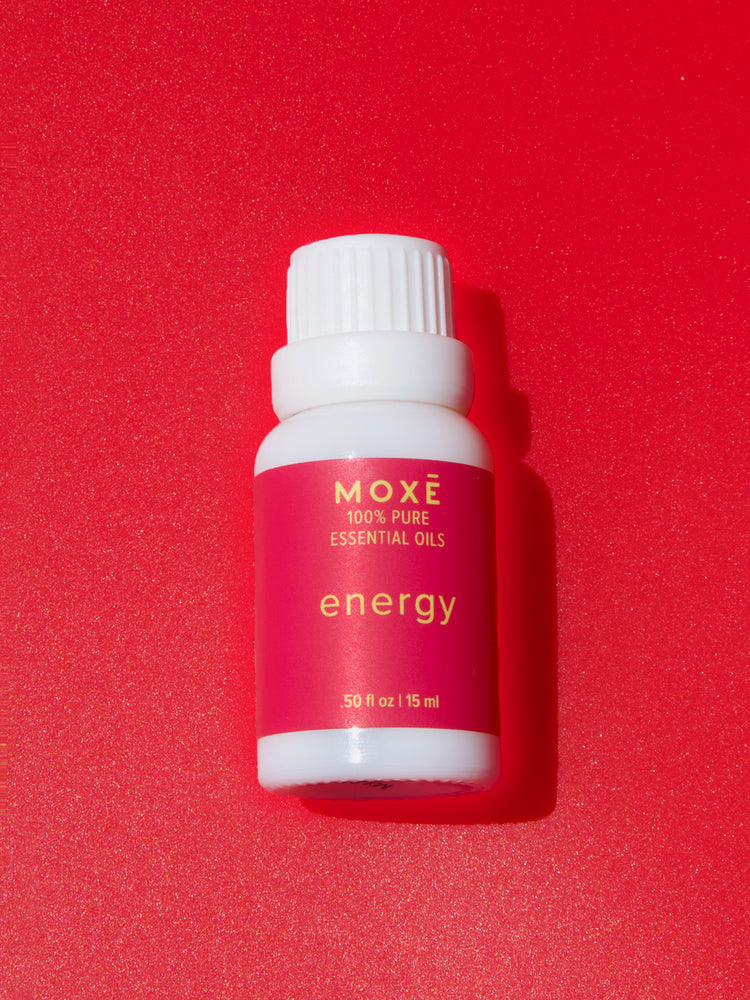 MOXĒ Energy Essential Oil with red background