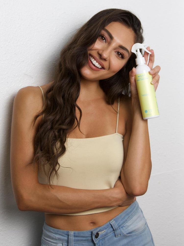 Girl Smiling After Using MOXĒ  Happy Room + Linen Spray