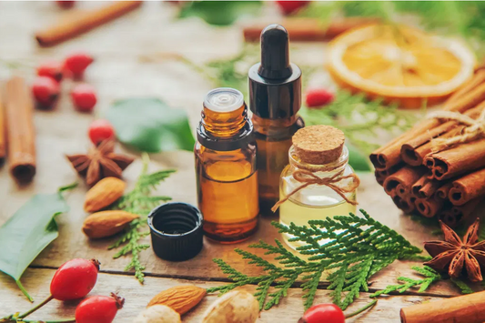 open essential oil bottles with christmas spices on a tables