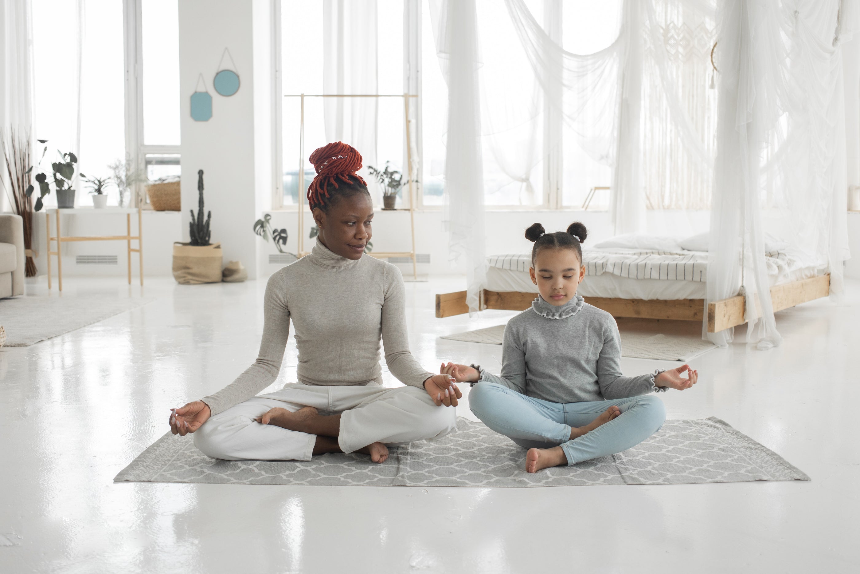 mother and daughter doing yoga on a clean yoga mat using yoga cleaning spray