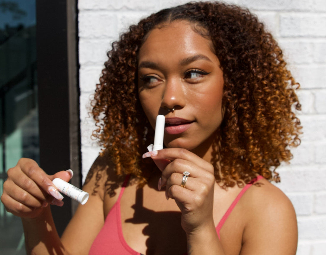 woman using essential oil inhaler