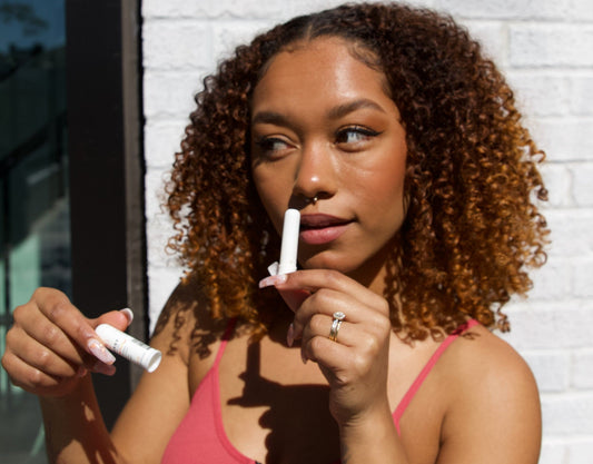 woman using essential oil inhaler