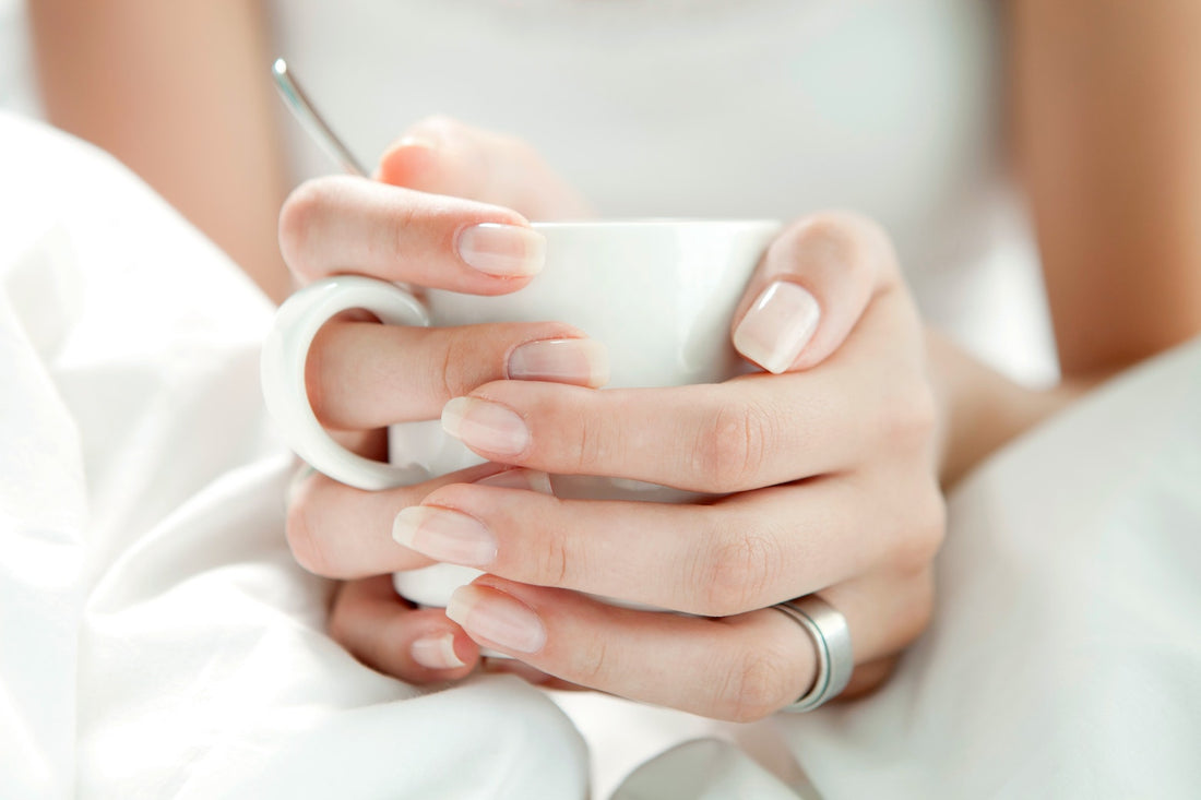 woman who uses essential oils for nails and dry cuticles to keep her nails healthy and strong