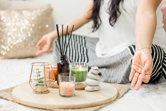 woman meditating with essential oils for emotional health and well being