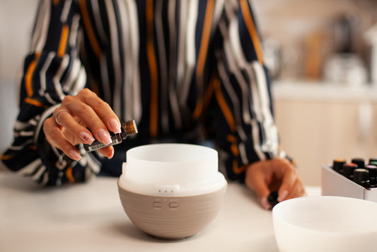 hand holding a bottle of essential oil