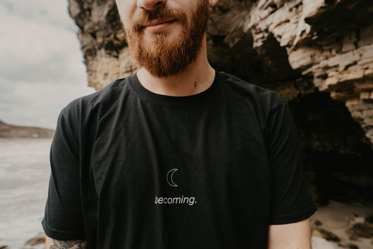 Shirtless man using Essential oils for beard growth