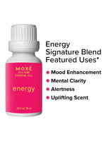 MOXĒ Energy Essential Oil with a hand holding it