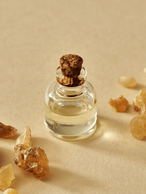 A bottle of Frankincense oil surrounded by Frankincense