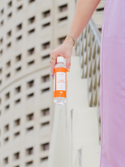 Girl holding MOXĒ  Unscented Hand Sanitizer