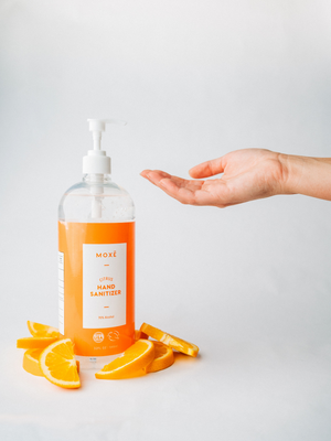 Person Using MOXĒ Citrus Hand Sanitizer