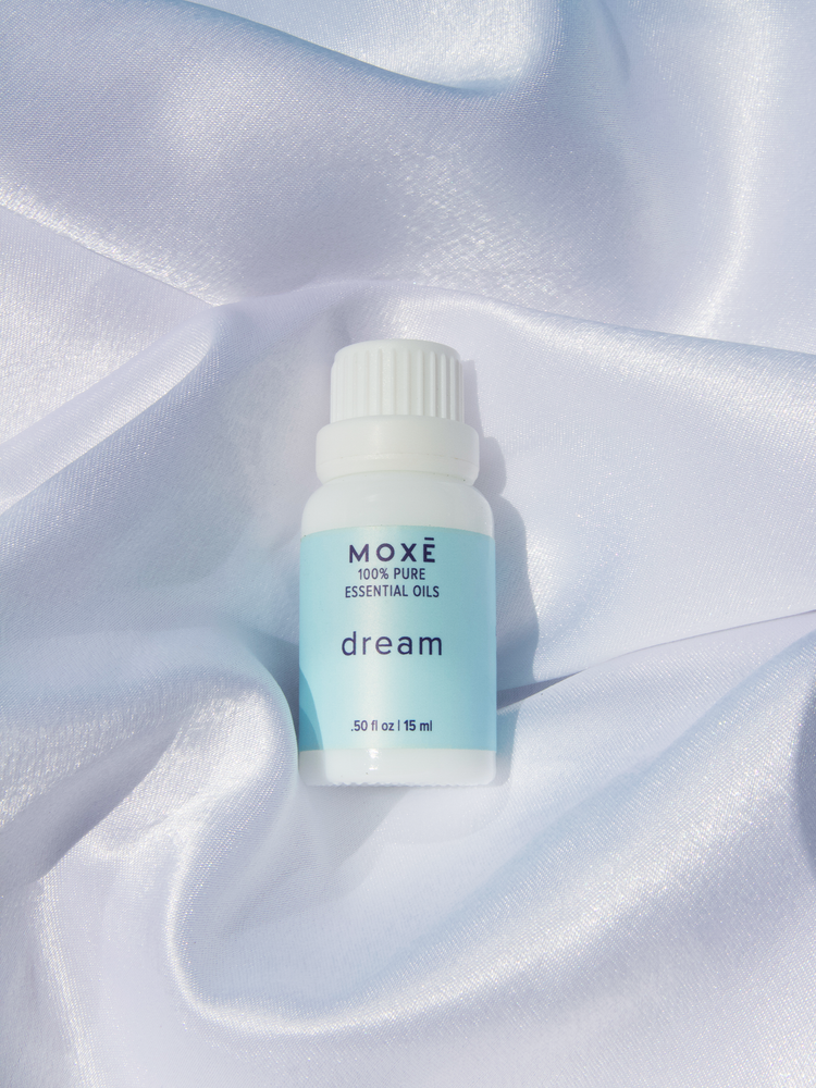 MOXĒ Dream Essential Oil with satin background