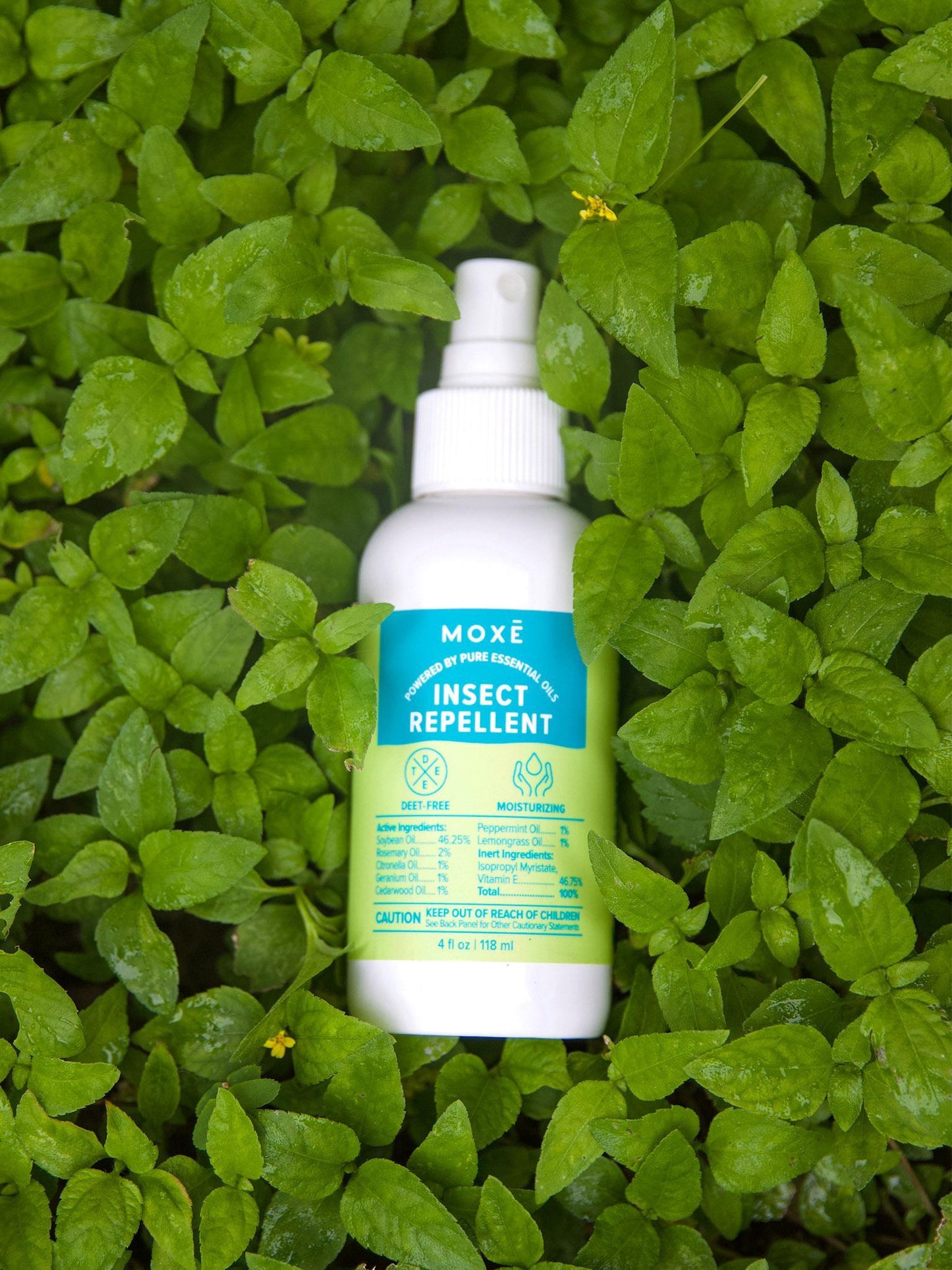 MOXĒ Insect Repellent laying in a bed of grass