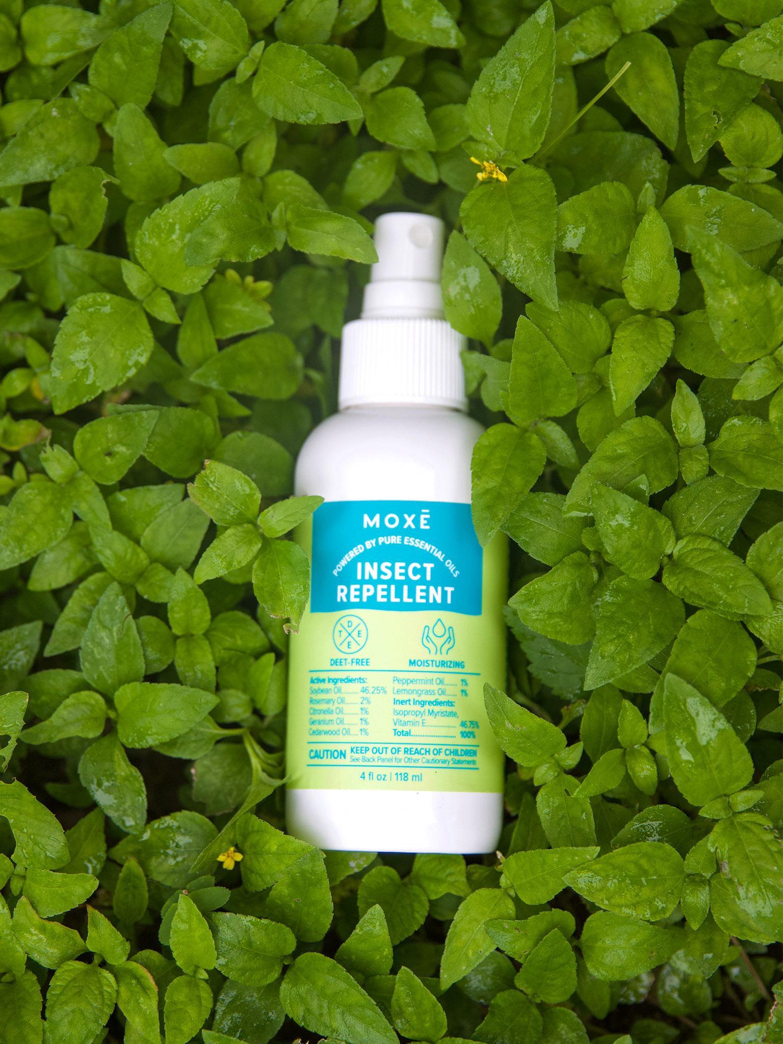 MOXĒ Insect Repellent laying in a bed of grass