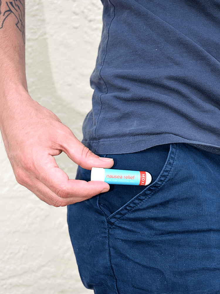 Man Taking Out the MOXĒ Nausea Relief Inhaler from his Pant's Pocket