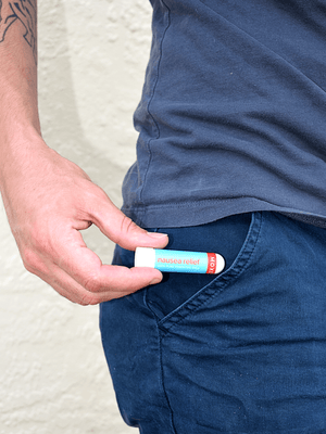 Man Taking Out the MOXĒ Nausea Relief Inhaler from his Pant's Pocket