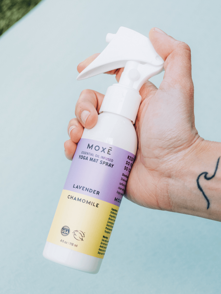 MOXĒ Lavender Chamomile Yoga Mat Spray held in hand